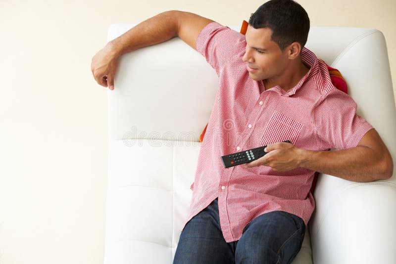 Overhead View of Man Relaxing on Sofa Watching Television Stock Photo