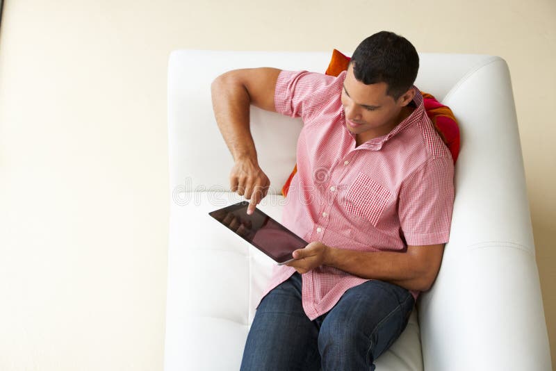 Overhead View of Man Relaxing on Sofa Watching Television Stock Image