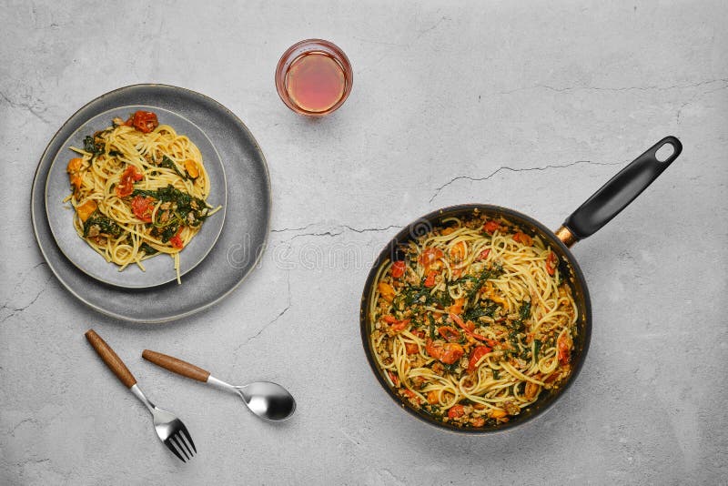 Overhead View of Spaghetti with Spinach Tomato Garlic and Olive Oil in a Pan. Stock Image