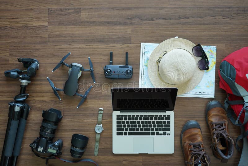 Overhead view of Traveler accessories, trip vacation, tourism mockup, backpack, camera, drone, shoes with map on wooden table background, top view