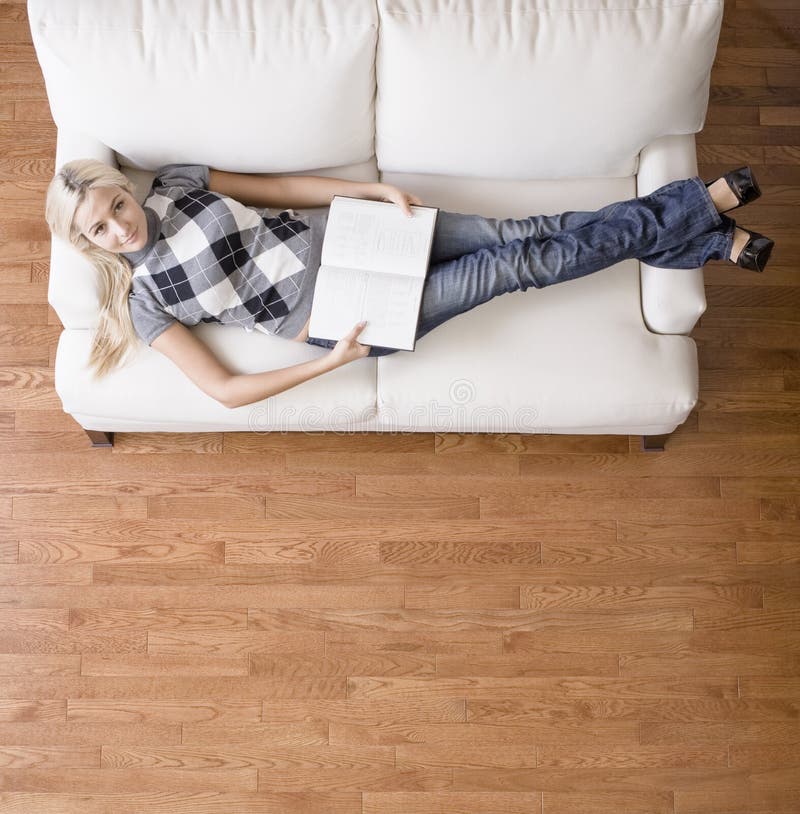 Overhead View Of Woman With Book On Couch Stock Image 