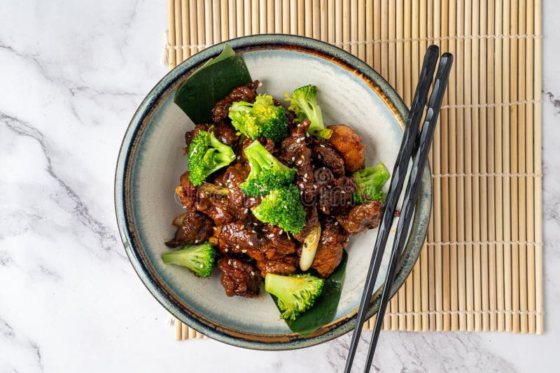 An overhead view of a delicious meal of Mongolian beef and broccoli served in a bowl. An overhead view of a delicious meal of Mongolian beef and broccoli served in a bowl