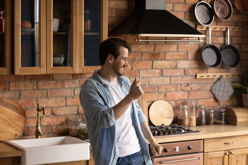 Overjoyed Young Man Dance Alone in Home Kitchen Stock Image - Image of funny, celebrate: 208441629 Overjoyed Young Man Dance Alone in Home Kitchen Stock Image - Image of funny, celebrate: 208441629
