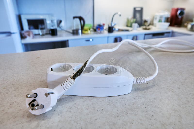Overload destroyed extension cord, which burned power cable, causing short circuit and almost causing fire. Damaged extension cord stock images, royalty-free photos and pictures