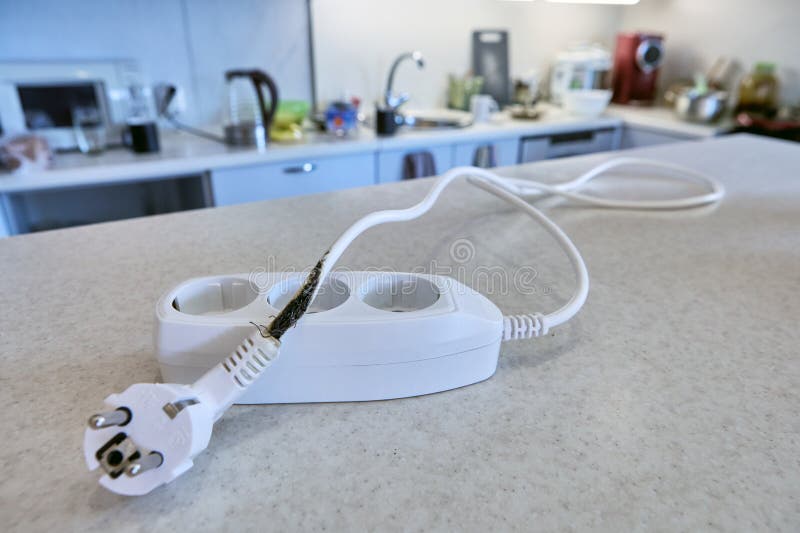 Overload burned out wires and insulation of extension cord with tee. Damaged extension cord stock images, royalty-free photos and pictures