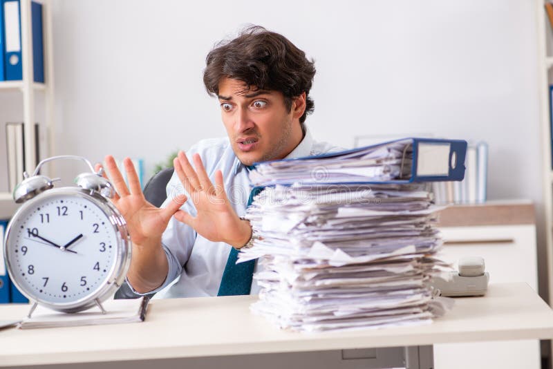The Overloaded Busy Employee with Too Much Work and Paperwork Stock