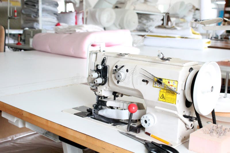 Overlock professionnel de machine à coudre dans l'atelier Équipement pour affiler, ourler ou piquer des vêtements dans un magasin photos stock Overlock professionnel de machine à coudre dans l'atelier Équipement pour affiler, ourler ou piquer des vêtements dans un magasin photos stock