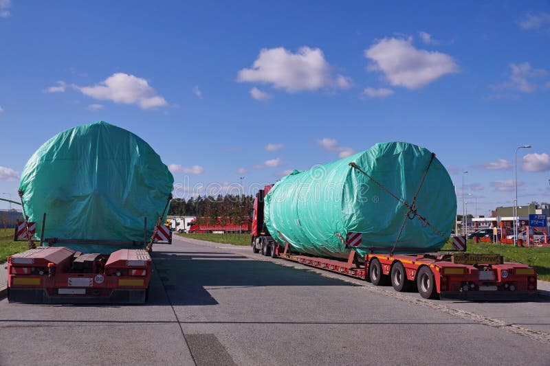 Oversize Load or exceptional convoy convoi exceptionnel. A truck with a special semi-trailer for transporting oversized loads stock photos Oversize Load or exceptional convoy convoi exceptionnel. A truck with a special semi-trailer for transporting oversized loads stock photos