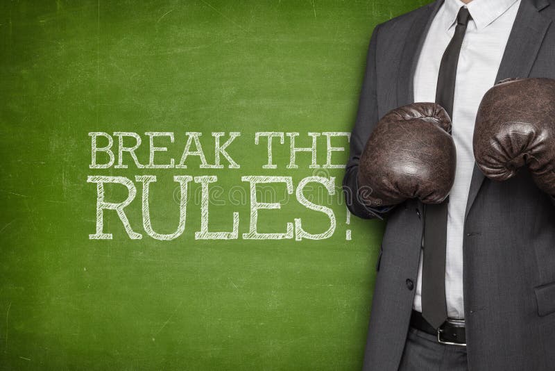 Break the rules on blackboard with businessman wearing boxing gloves. Break the rules on blackboard with businessman wearing boxing gloves