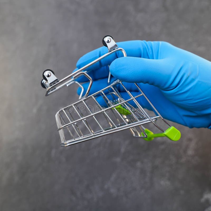 Overturned Empty Grocery Basket and a Hand in a Medical Glove Stock
