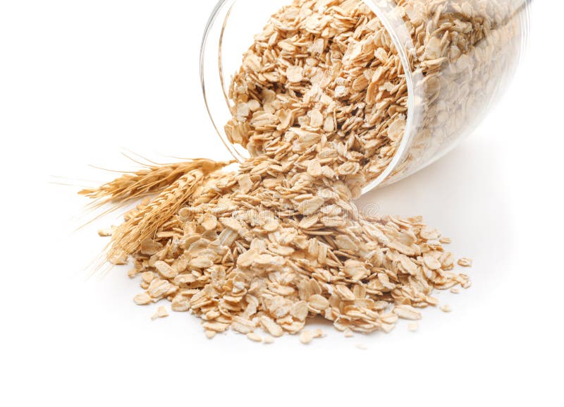 Overturned glass jar with raw oatmeal on white background, closeup stock photo Overturned glass jar with raw oatmeal on white background, closeup stock photo