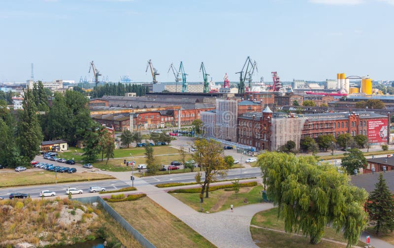 Overview of the city Gdansk and the heavy cranes of the Shipyard.