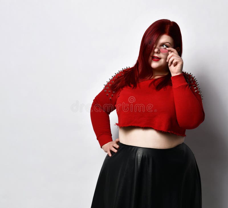 Overweight Redhead Woman In Red Spiked Top Black Leather Skirt Sh