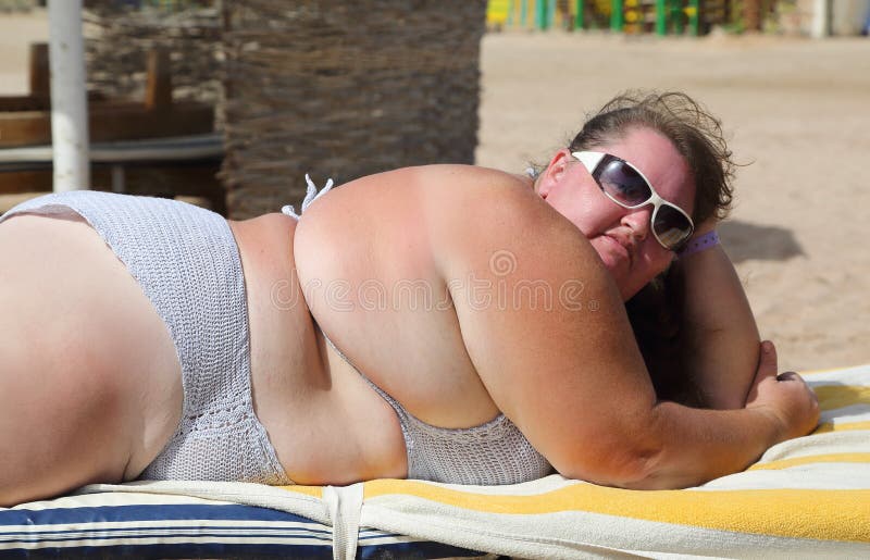 Overweight woman on beach stock image. Image of lying - 58754153