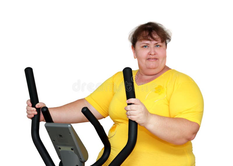 Overweight woman exercising on trainer royalty free stock images