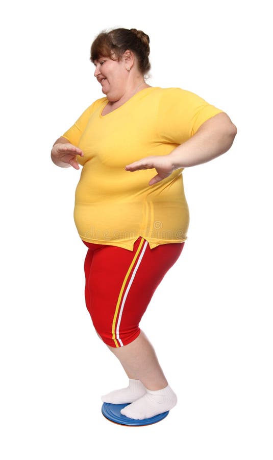Overweight woman on gymnastic disc royalty free stock photography