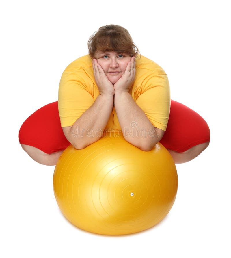 Overweight woman sitting with gym ball royalty free stock images