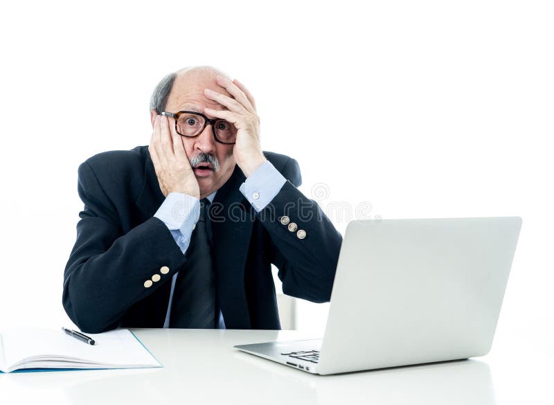 Overwhelmed and tired old businessman working with laptop feeling angry at office stock photography Overwhelmed and tired old businessman working with laptop feeling angry at office stock photography