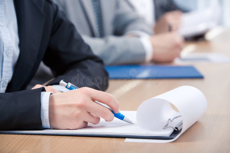 Human hand with pen over paper ready to write something. Human hand with pen over paper ready to write something