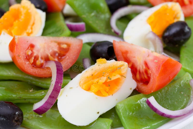 Boiled egg, tomato, green beans and olives. Boiled egg, tomato, green beans and olives