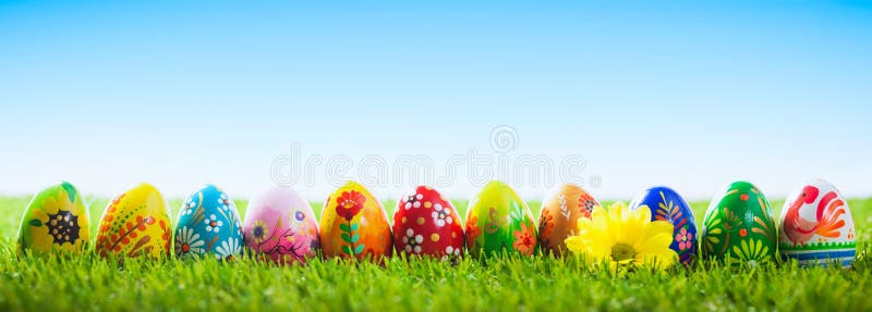 Colorful hand painted Easter eggs on grass. Banner, panoramic composition. Traditional decoration, unique handmade design. Colorful hand painted Easter eggs on grass. Banner, panoramic composition. Traditional decoration, unique handmade design.