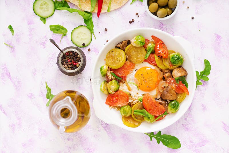 Ovos fritos com vegetais - shakshuka e pepino, rabanete da melancia e rúcula frescos fotografia de stock Ovos fritos com vegetais - shakshuka e pepino, rabanete da melancia e rúcula frescos fotografia de stock