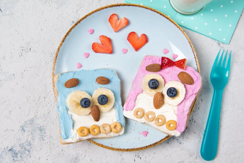 Owl toasts with cream cheese, fruits and cereals, food for kids idea, top view