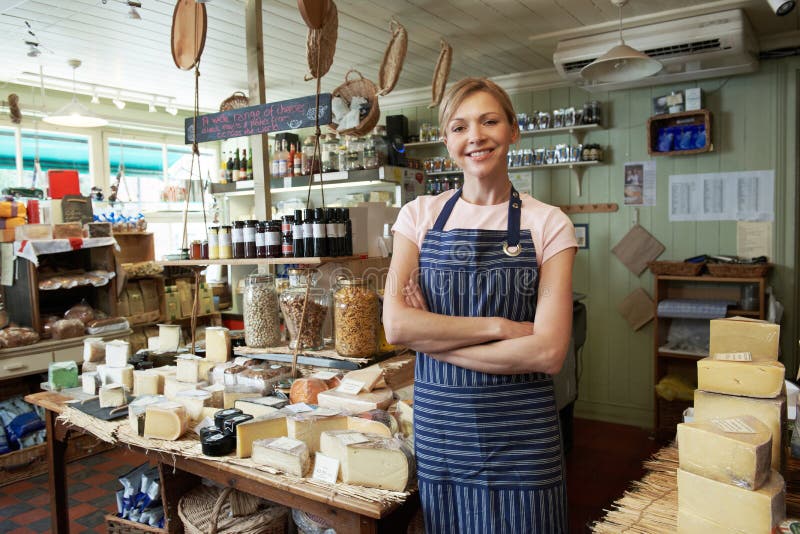 Owner Of Delicatessen Standing In Shop royalty free stock images