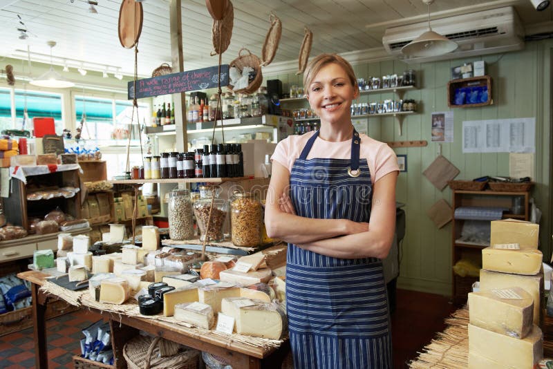 Owner Of Delicatessen Standing In Shop