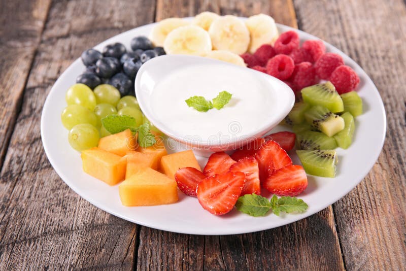 Fruits and yogurt dip on wood. Fruits and yogurt dip on wood