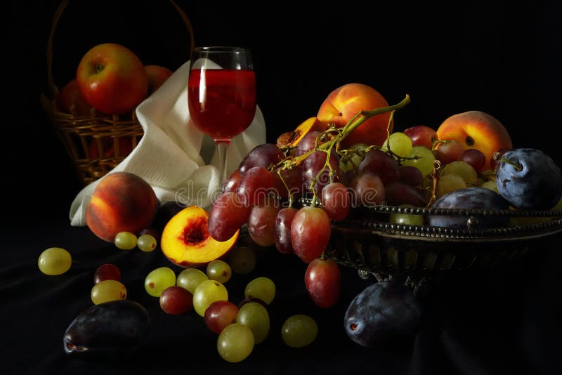Basket of apples, vase with grapes, peaches, plums and a glass of red wine on a dark background in the style of ancient Dutch artists. Basket of apples, vase with grapes, peaches, plums and a glass of red wine on a dark background in the style of ancient Dutch artists