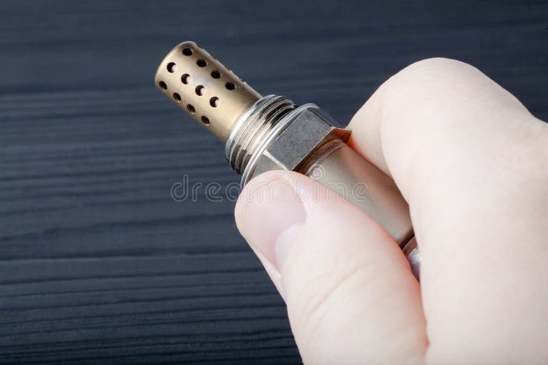 Oxygen sensor for gasoline and diesel engines in the hand. lambda probe is reliable component to optimize your car& x27;s royalty free stock photos