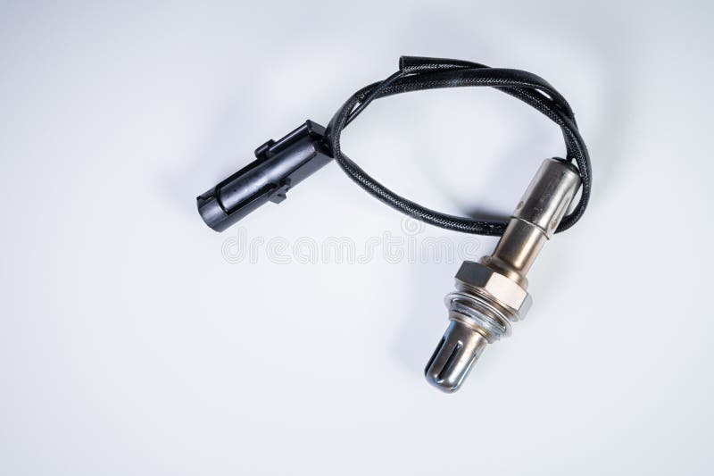 The oxygen sensor is a new lambda sensor. Spare parts on the car on a gray gradient background stock images