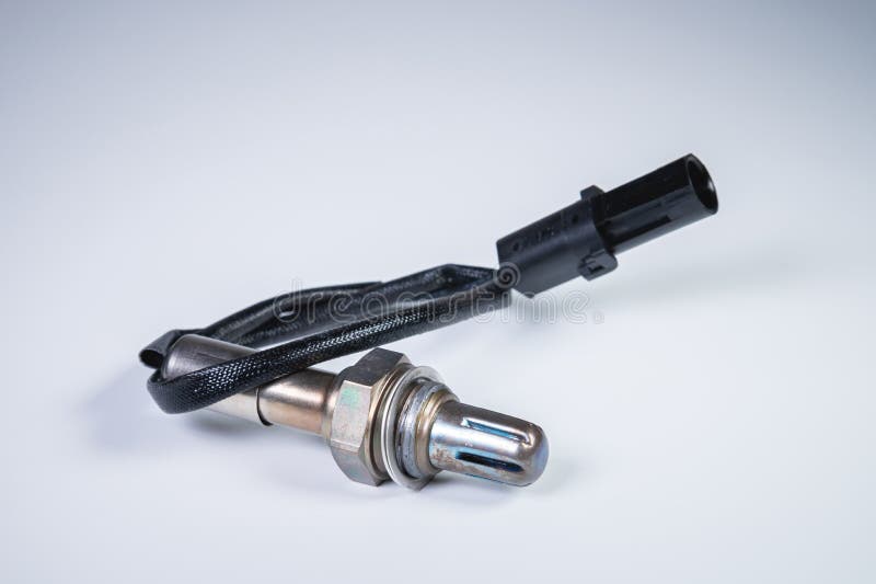 The oxygen sensor is a new lambda sensor. Spare parts on the car on a gray gradient background stock photos
