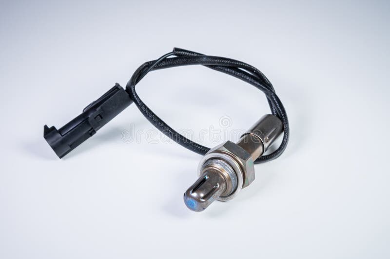 The oxygen sensor is a new lambda sensor. Spare parts on the car on a gray gradient background stock photo