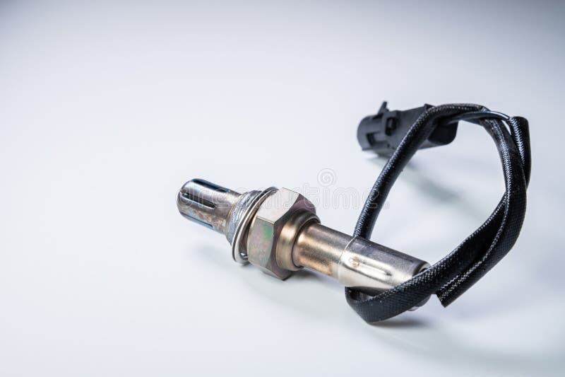 The oxygen sensor is a new lambda sensor. Spare parts on the car on a gray gradient background royalty free stock photo