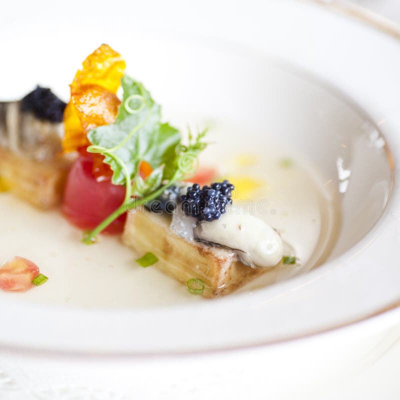 Oysters with black caviar stock photos