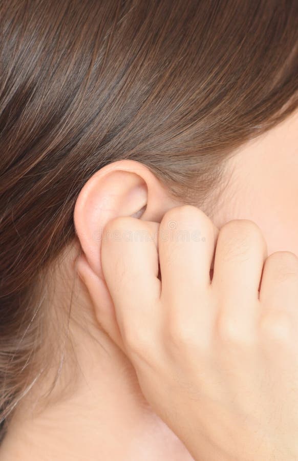 Young woman holding her ear. Young woman holding her ear