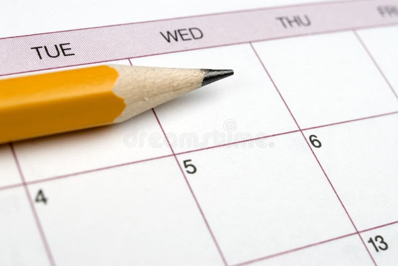 Closeup image of pencil laying on a calendar. Closeup image of pencil laying on a calendar.