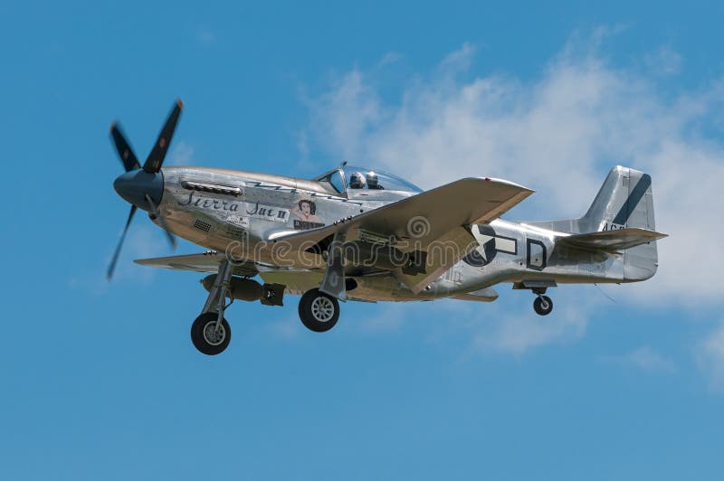 EDEN PRAIRIE, MN - JULY 16, 2016: P-51 Mustang “Sierra Sue II” flies by at air show. The P-51 Mustang was a long-range, single-seat fighter used primarily during World War II. EDEN PRAIRIE, MN - JULY 16, 2016: P-51 Mustang “Sierra Sue II” flies by at air show. The P-51 Mustang was a long-range, single-seat fighter used primarily during World War II.