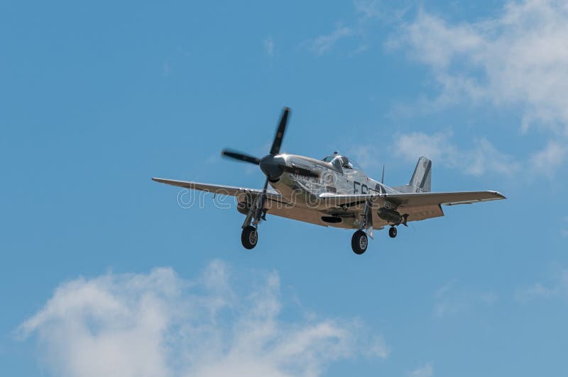 EDEN PRAIRIE, MN - JULY 16, 2016: P-51 Mustang “Sierra Sue II” flies in at air show. The P-51 Mustang was a long-range, single-seat fighter used primarily during World War II. EDEN PRAIRIE, MN - JULY 16, 2016: P-51 Mustang “Sierra Sue II” flies in at air show. The P-51 Mustang was a long-range, single-seat fighter used primarily during World War II.