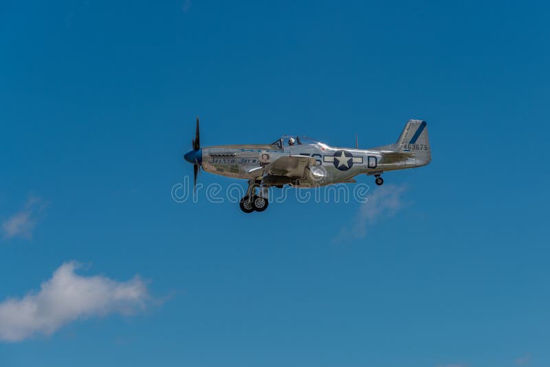 EDEN PRAIRIE, MN - JULY 16, 2016: P-51 Mustang “Sierra Sue II” flies in with gear down at air show. The P-51 Mustang was a long-range, single-seat fighter used primarily during World War II. EDEN PRAIRIE, MN - JULY 16, 2016: P-51 Mustang “Sierra Sue II” flies in with gear down at air show. The P-51 Mustang was a long-range, single-seat fighter used primarily during World War II.