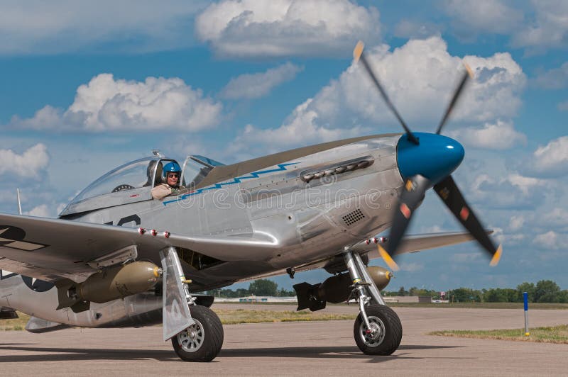 EDEN PRAIRIE, MN - JULY 16, 2016: P-51 Mustang “Sierra Sue II” turns on taxiway at air show. The P-51 Mustang was a long-range, single-seat fighter used primarily during World War II. EDEN PRAIRIE, MN - JULY 16, 2016: P-51 Mustang “Sierra Sue II” turns on taxiway at air show. The P-51 Mustang was a long-range, single-seat fighter used primarily during World War II.