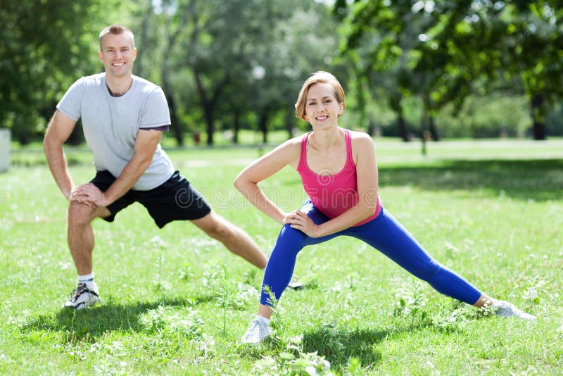 Man and women doing stretching exercises. Man and women doing stretching exercises