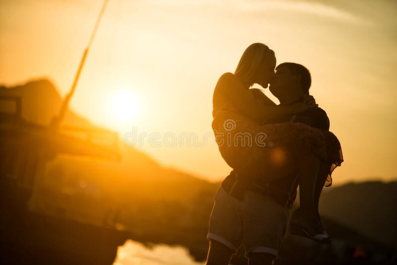 Paare in der Liebe, die bei Sonnenuntergang küsst Schattenbild stockbild Paare in der Liebe, die bei Sonnenuntergang küsst Schattenbild stockbild