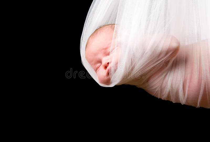 Stork Baby Package. 14 days old newborn baby girl carried in white cloth. Stork Baby Package. 14 days old newborn baby girl carried in white cloth