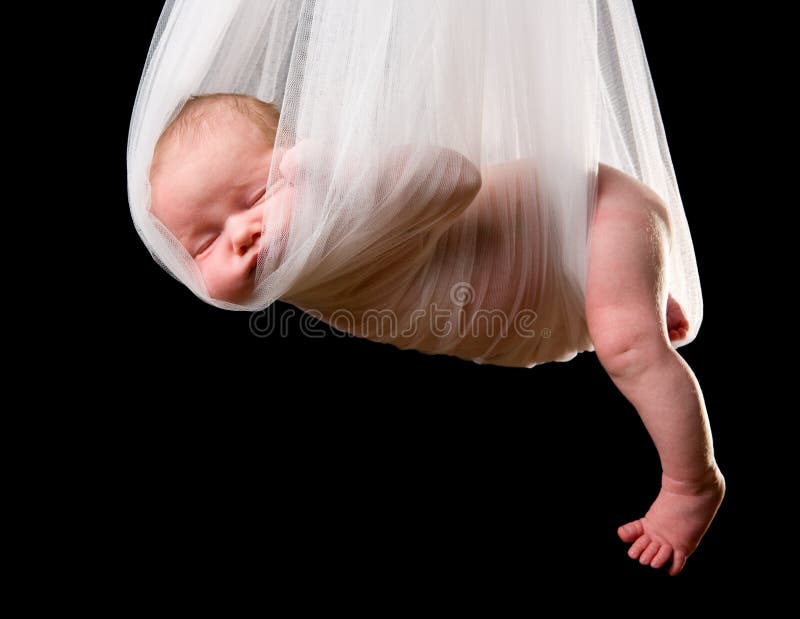 Stork Baby Package. 14 days old newborn baby girl carried in white cloth. Stork Baby Package. 14 days old newborn baby girl carried in white cloth