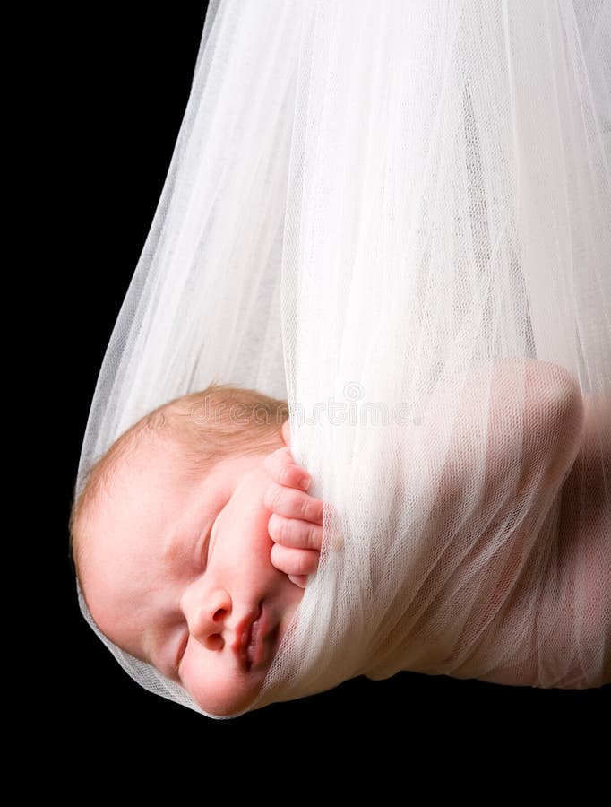 Stork Baby Package. 14 days old newborn baby girl carried in white cloth. Stork Baby Package. 14 days old newborn baby girl carried in white cloth