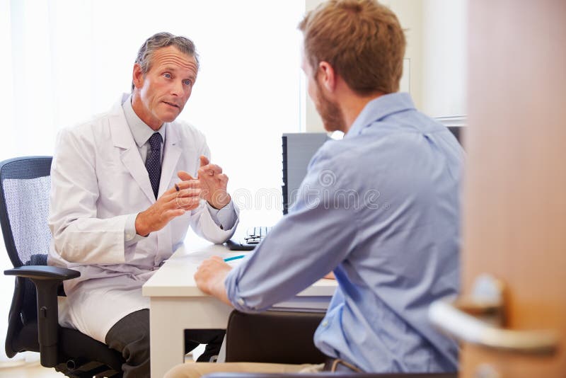 Paciente masculino tendo a consulta com doutor In Office