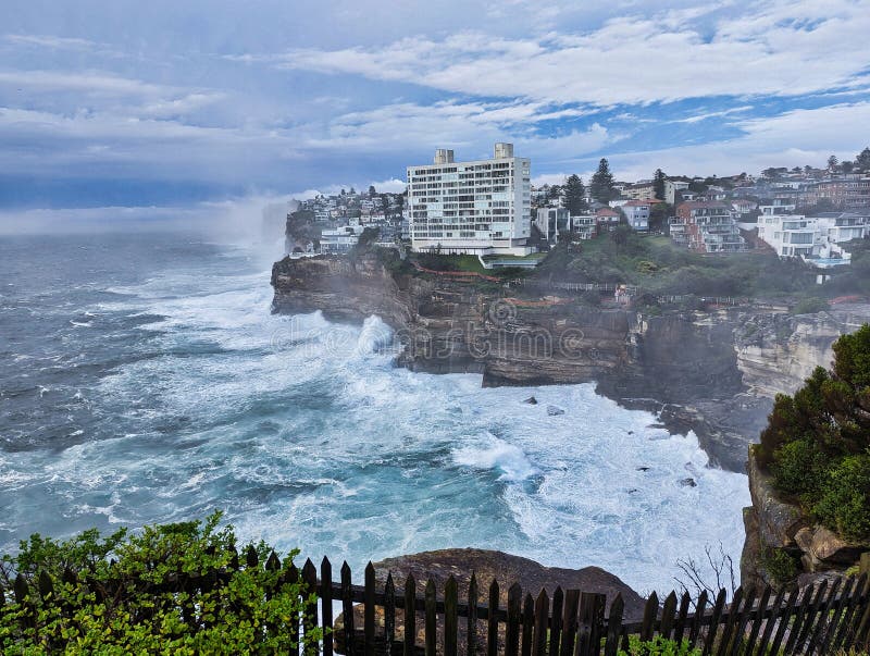High-level view of wild storm Pacific Ocean waves crashing onto the sandstone cliffs at Dover Heights at Diamond Bay, Vaucluse, Sydney, NSW, Australia, with mist from ocean spray. Waves crashing cliffs stock images, royalty-free photos and pictures